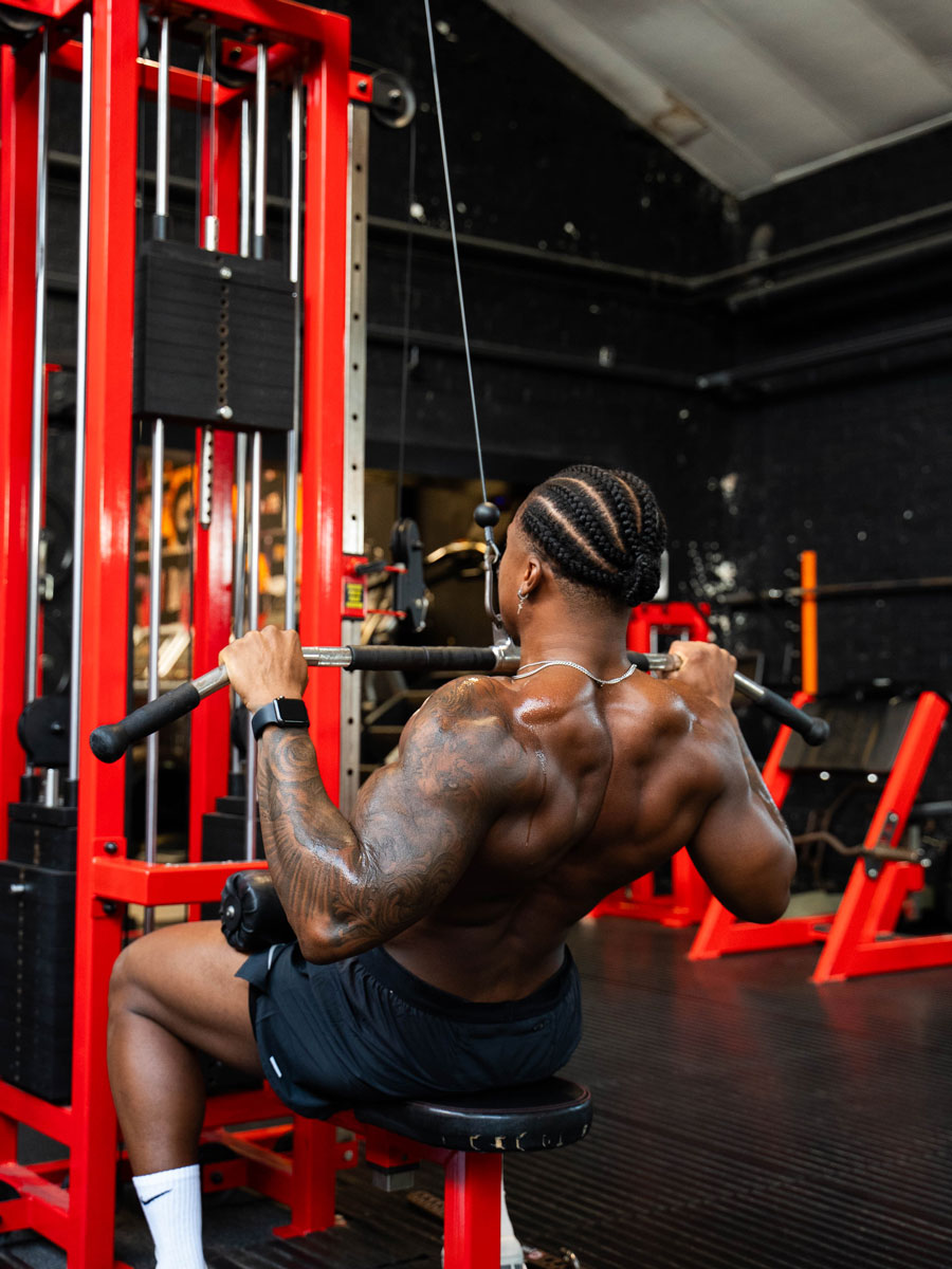 The coach is exercising in the gym.